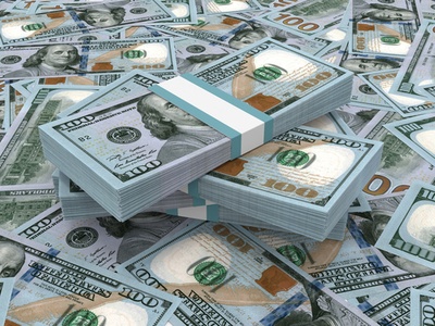 dollar bills in packs in a pile on a table